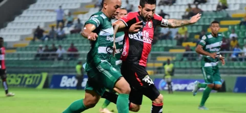 Misael Martínez (verde) disputa un balón con Jhonathan Agudelo - VizzorImage / Adamis Guerra